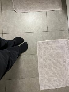 Standard builder's floor tiles (3-year-old apartment). Rugs salvaged from the recycling room. At least the socks don't have holes.